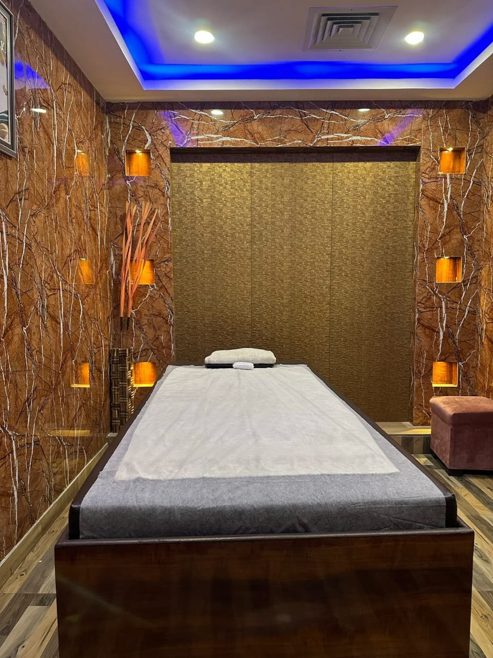 Modern spa room at Sunshine Wellness Spawith soft lighting and comfortable massage tables