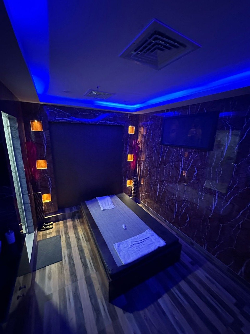 Modern spa room at Sunshine Wellness Spawith soft lighting and comfortable massage tables