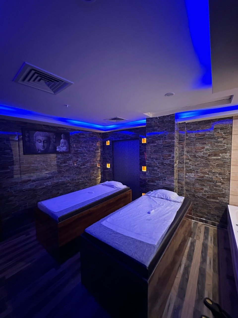 Modern spa room at Sunshine Wellness Spawith soft lighting and comfortable massage tables